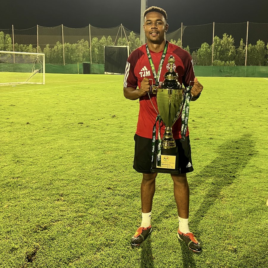 TJ holding the Carlsberg Cup as winning team coach